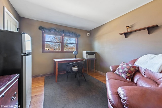 office with light wood-style flooring, visible vents, and baseboards