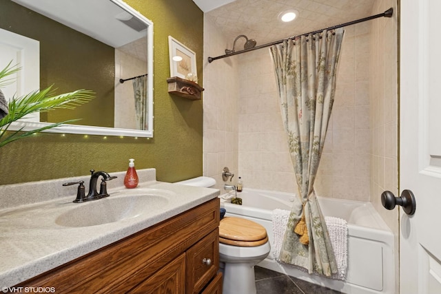 bathroom with shower / bathtub combination with curtain, toilet, vanity, and a textured wall