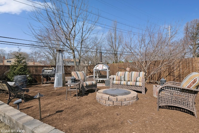 view of yard featuring a fenced backyard and an outdoor fire pit