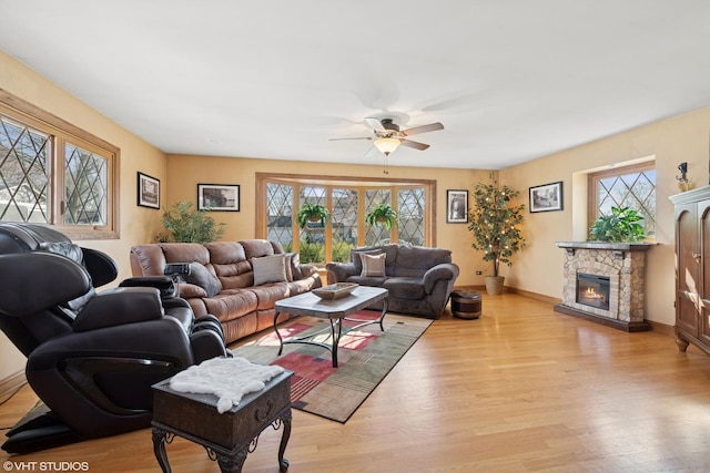 living room with a healthy amount of sunlight, wood finished floors, and ceiling fan