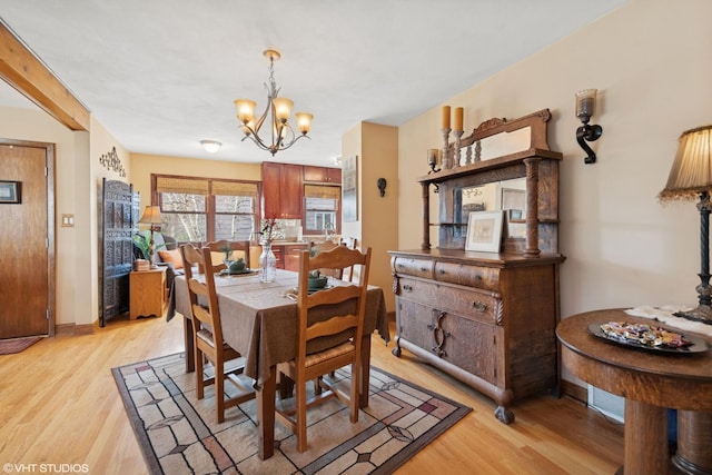 dining room with an inviting chandelier and light wood-type flooring