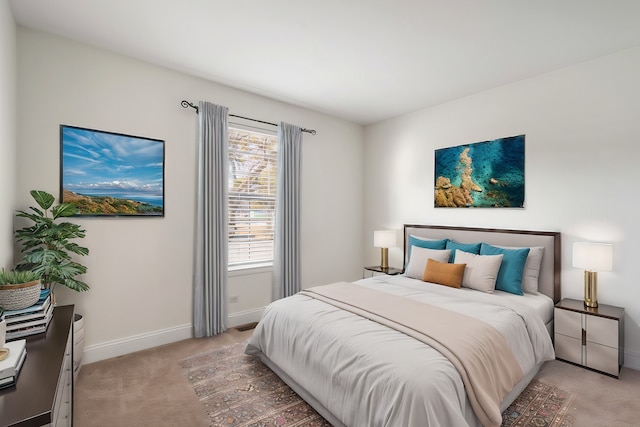 bedroom with light carpet and baseboards