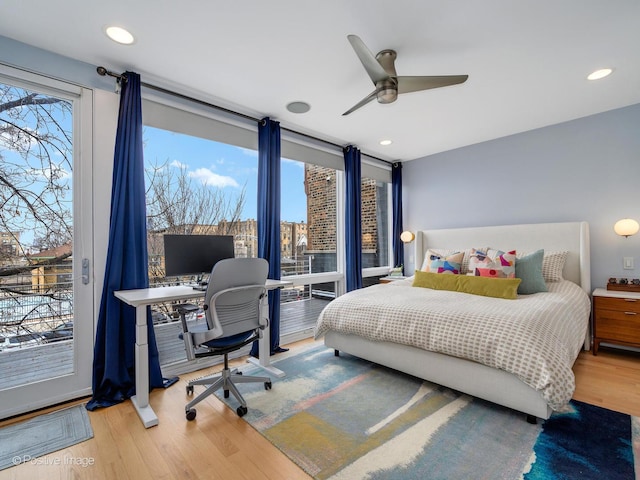 bedroom featuring access to exterior, wood finished floors, and recessed lighting