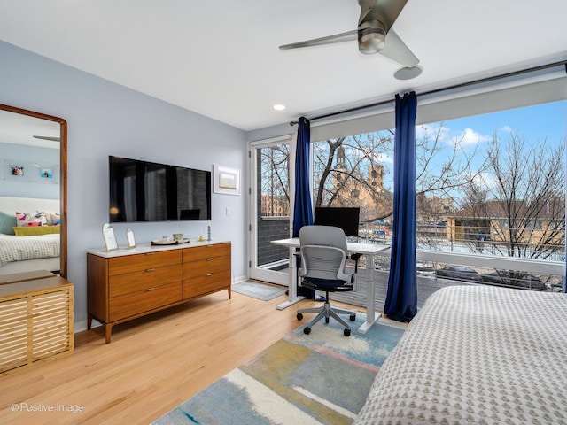 bedroom featuring access to exterior, baseboards, light wood finished floors, and a ceiling fan