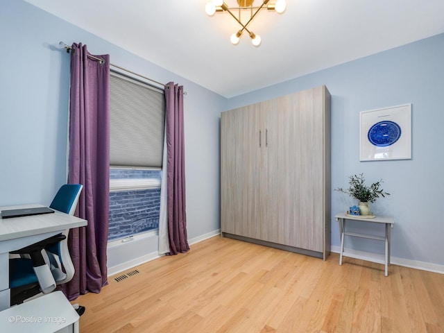 office with light wood-type flooring, visible vents, baseboards, and an inviting chandelier