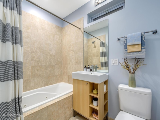 full bathroom featuring vanity, a combined bath / shower with jetted tub, and toilet