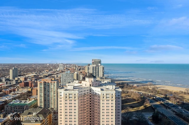 birds eye view of property featuring a water view and a city view