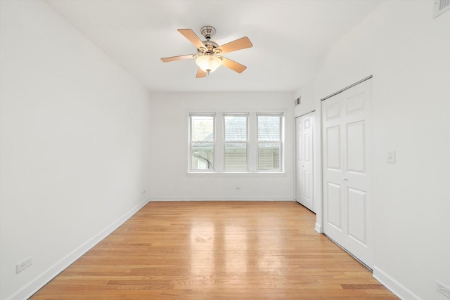 unfurnished bedroom with visible vents, baseboards, light wood finished floors, and ceiling fan