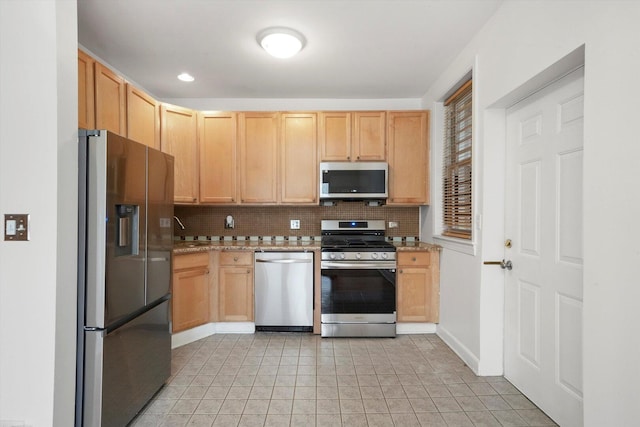 kitchen featuring tasteful backsplash, light tile patterned floors, light brown cabinets, and stainless steel appliances