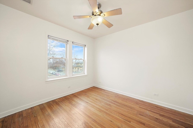 empty room with baseboards, light wood-style floors, and ceiling fan