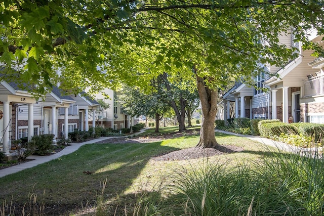 view of home's community featuring a residential view and a yard