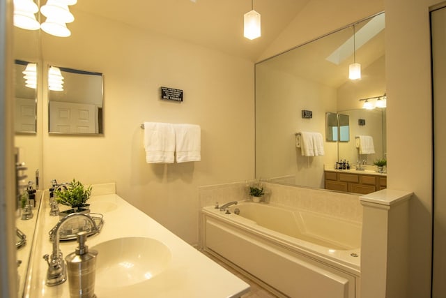 bathroom featuring lofted ceiling, double vanity, a sink, and a bath