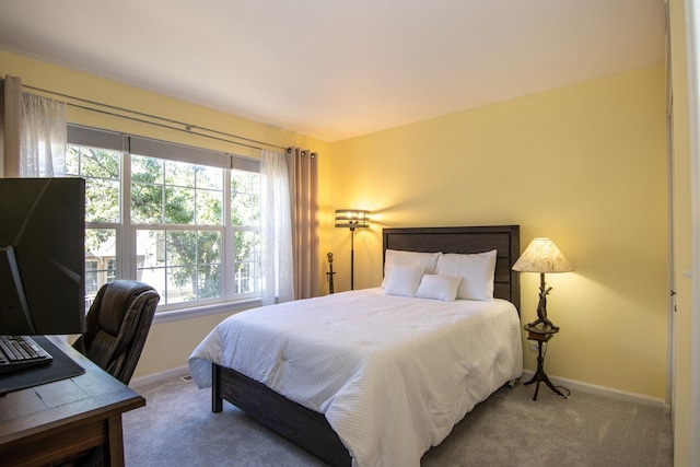 carpeted bedroom with baseboards