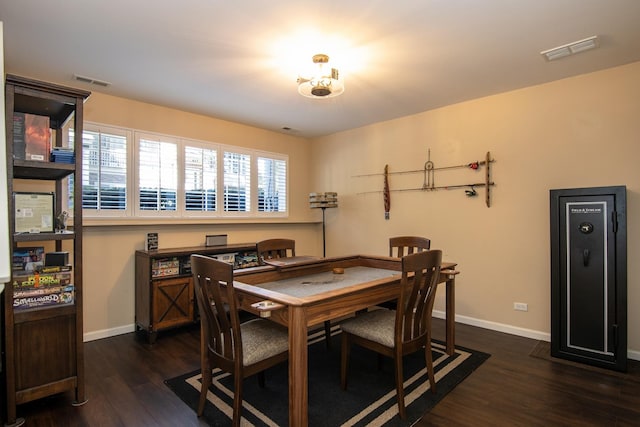 dining space with dark wood-style floors, visible vents, and baseboards