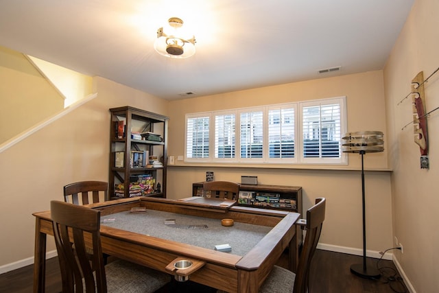 home office featuring plenty of natural light, visible vents, baseboards, and dark wood-style flooring