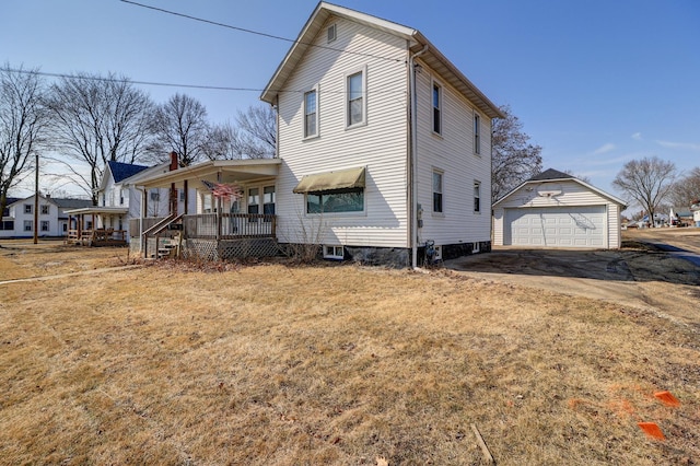 view of side of home with a garage, a lawn, and an outdoor structure