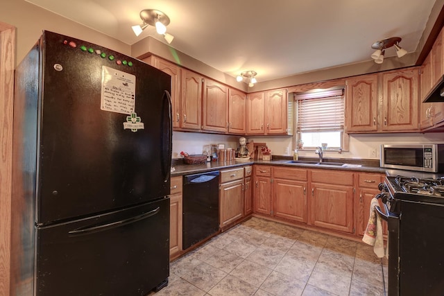 kitchen featuring light tile patterned floors, a sink, brown cabinets, black appliances, and dark countertops