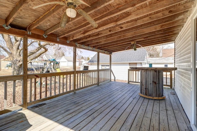 deck featuring ceiling fan and an outdoor structure