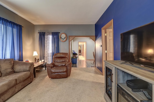 living room featuring carpet floors and lofted ceiling