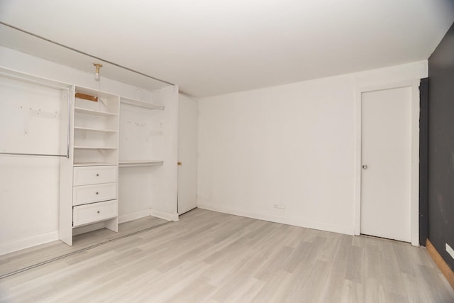 unfurnished bedroom featuring light wood finished floors and baseboards