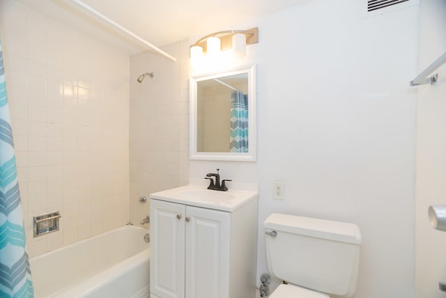 bathroom featuring toilet, shower / tub combo, and vanity