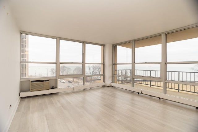 unfurnished sunroom with a wealth of natural light and a wall mounted AC