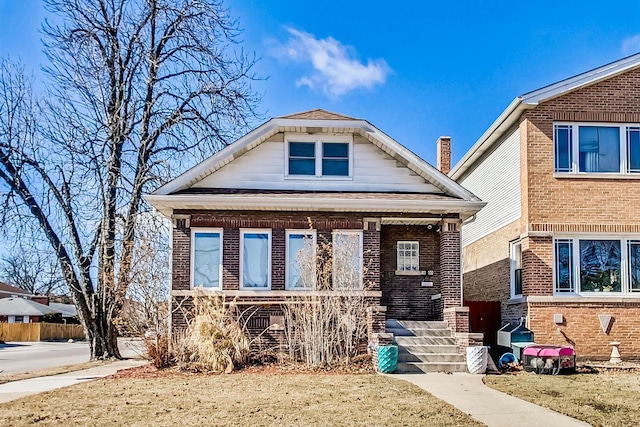 view of front facade featuring covered porch and brick siding