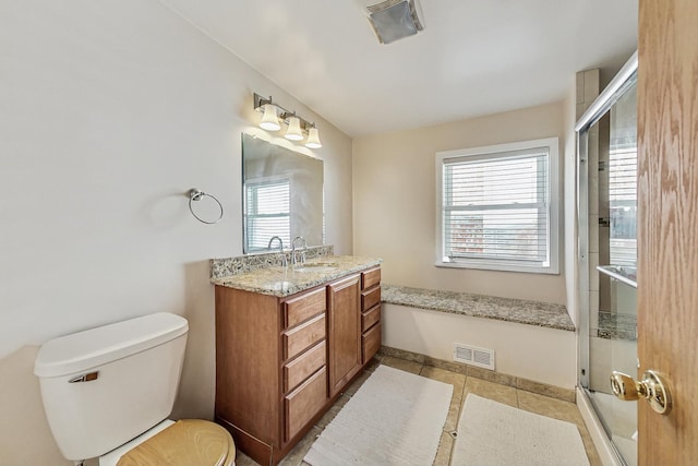 full bathroom featuring visible vents, a shower with door, vanity, and toilet