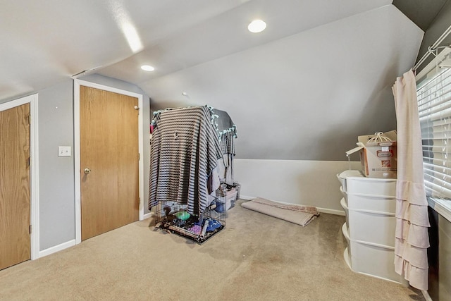 interior space with carpet floors, baseboards, vaulted ceiling, and recessed lighting