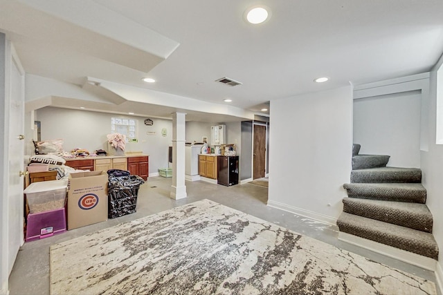 below grade area with recessed lighting, visible vents, stairway, washer / dryer, and baseboards