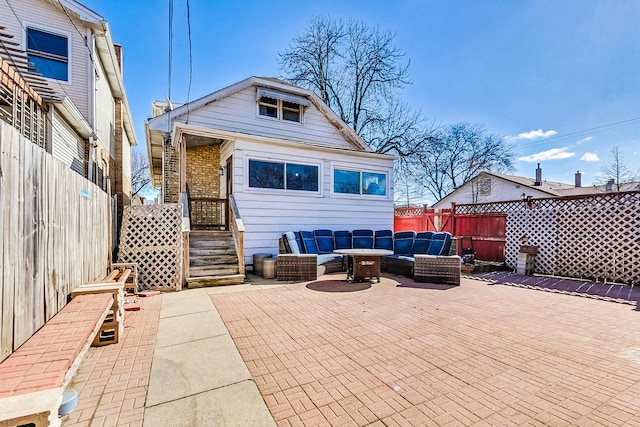 rear view of property with a patio area, fence, an outdoor living space, and brick siding