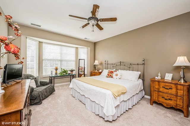 bedroom featuring light colored carpet, visible vents, and baseboards