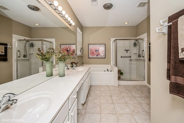 bathroom with visible vents, a stall shower, a garden tub, and a sink