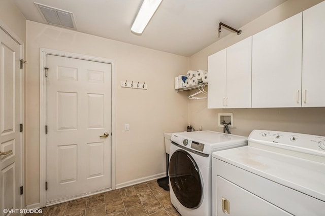 washroom with visible vents, cabinet space, independent washer and dryer, and baseboards