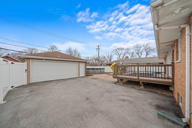 detached garage featuring fence