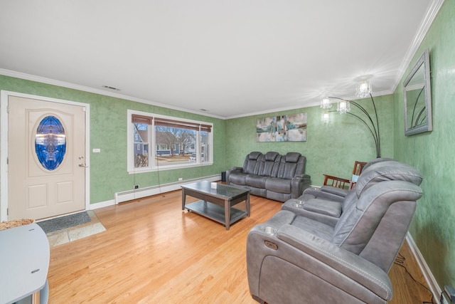 living area with crown molding, visible vents, baseboard heating, wood finished floors, and baseboards