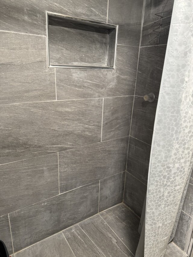 bathroom with tiled shower