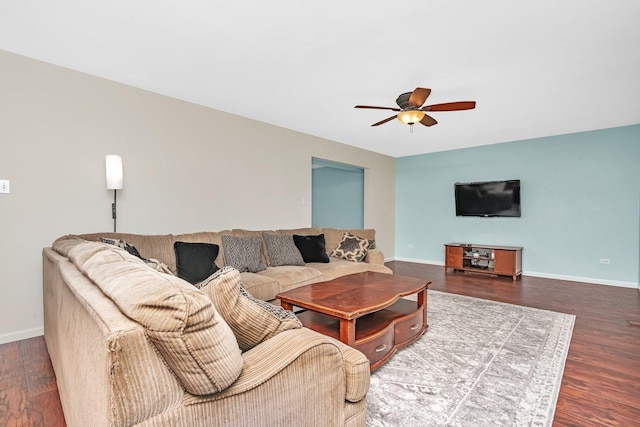 living area featuring ceiling fan, baseboards, and wood finished floors