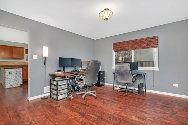 home office featuring baseboards and wood finished floors