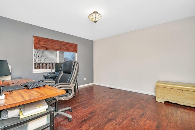 office space with visible vents, baseboards, and wood finished floors