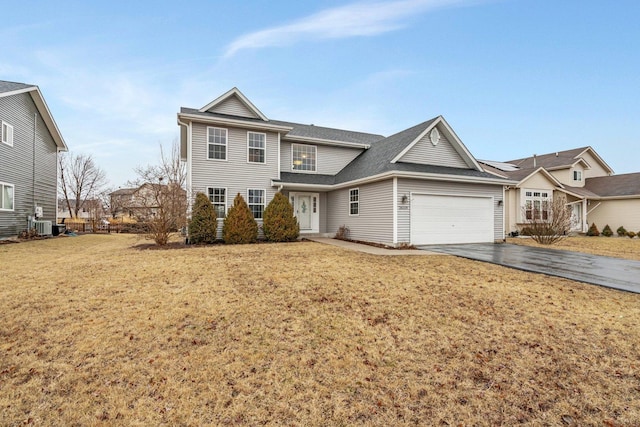 traditional home featuring a garage, cooling unit, driveway, and a front lawn