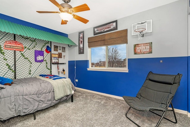 carpeted bedroom with ceiling fan and baseboards