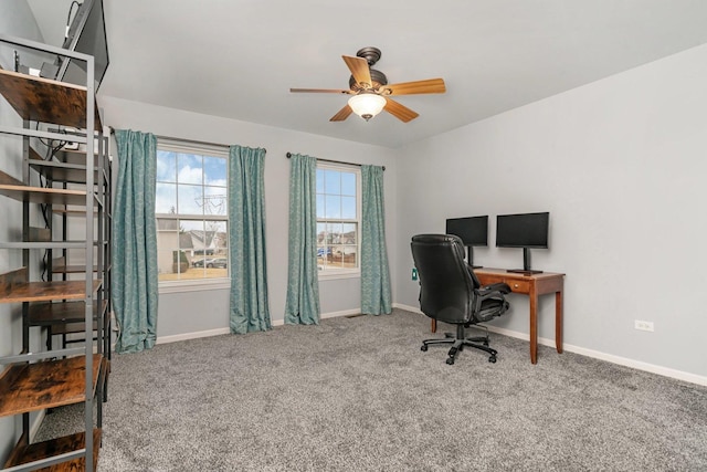 carpeted home office featuring a ceiling fan and baseboards