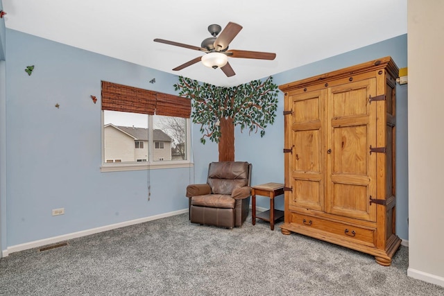 sitting room featuring baseboards, visible vents, ceiling fan, and carpet flooring