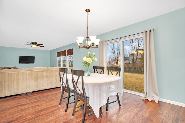 dining room with a healthy amount of sunlight, baseboards, and wood finished floors