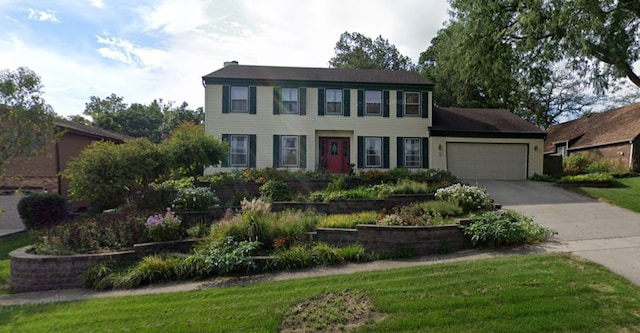 colonial home featuring a garage and concrete driveway