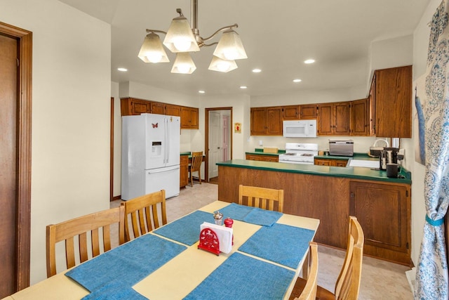 dining area with an inviting chandelier and recessed lighting