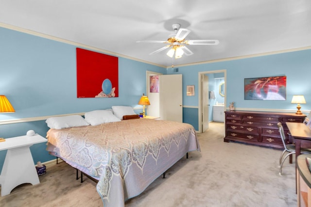 carpeted bedroom featuring ceiling fan, ornamental molding, and ensuite bath