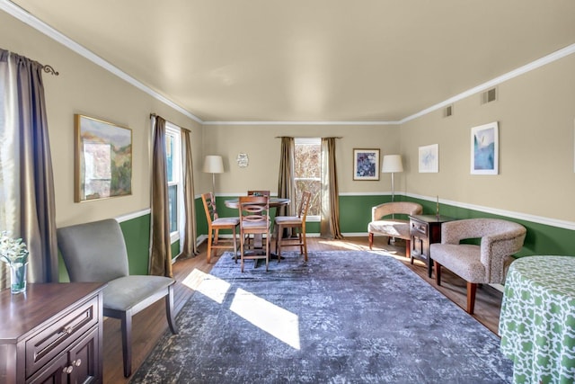 interior space with visible vents, crown molding, and wood finished floors