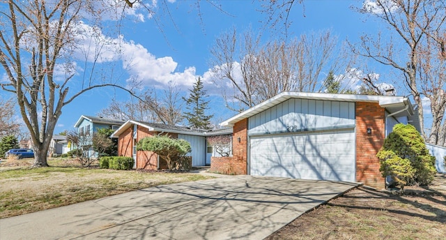 mid-century inspired home with brick siding, an attached garage, concrete driveway, and a front yard